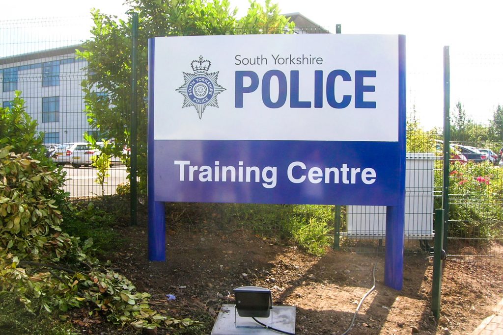 Post mounted training centre sign to building entrance.