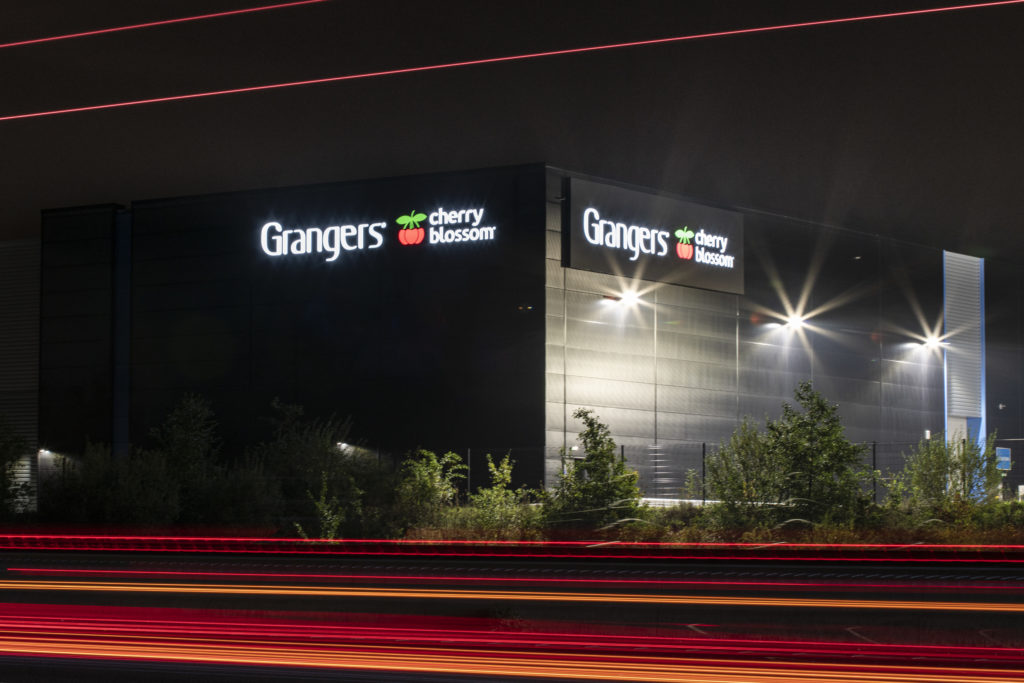 Illuminated flex-face sign at Grangers at night from the A38.